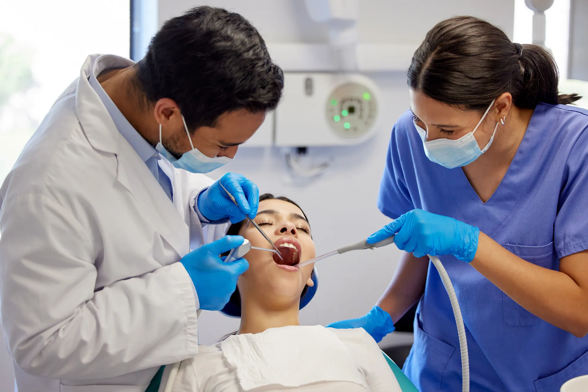 Dentist and assistant working with a patient