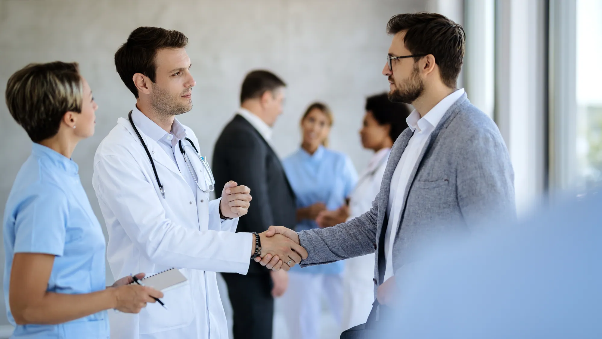 Doctor greeting a business partner