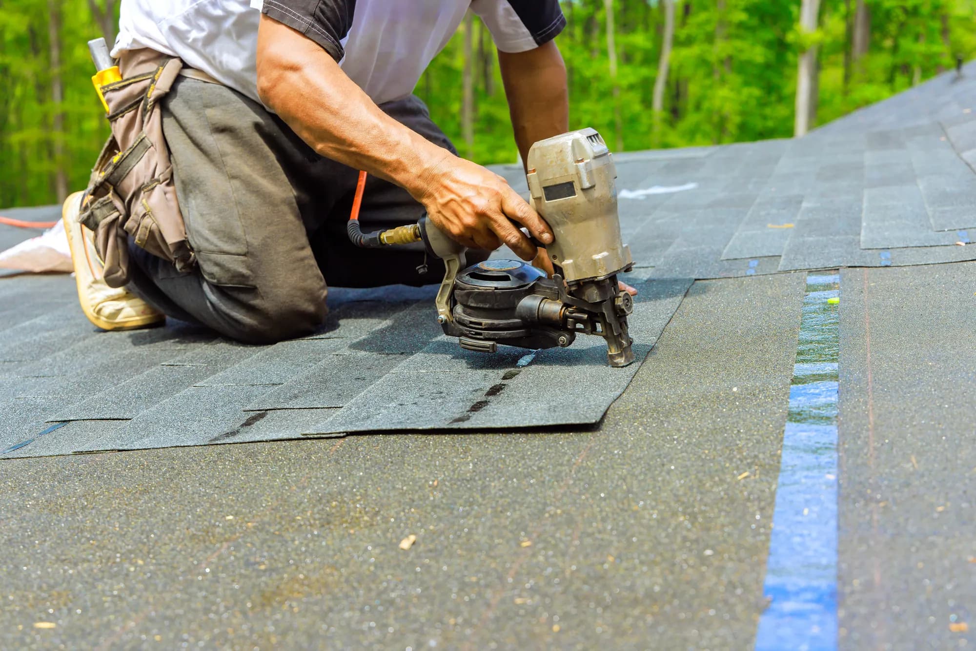 Roofer installing shingles